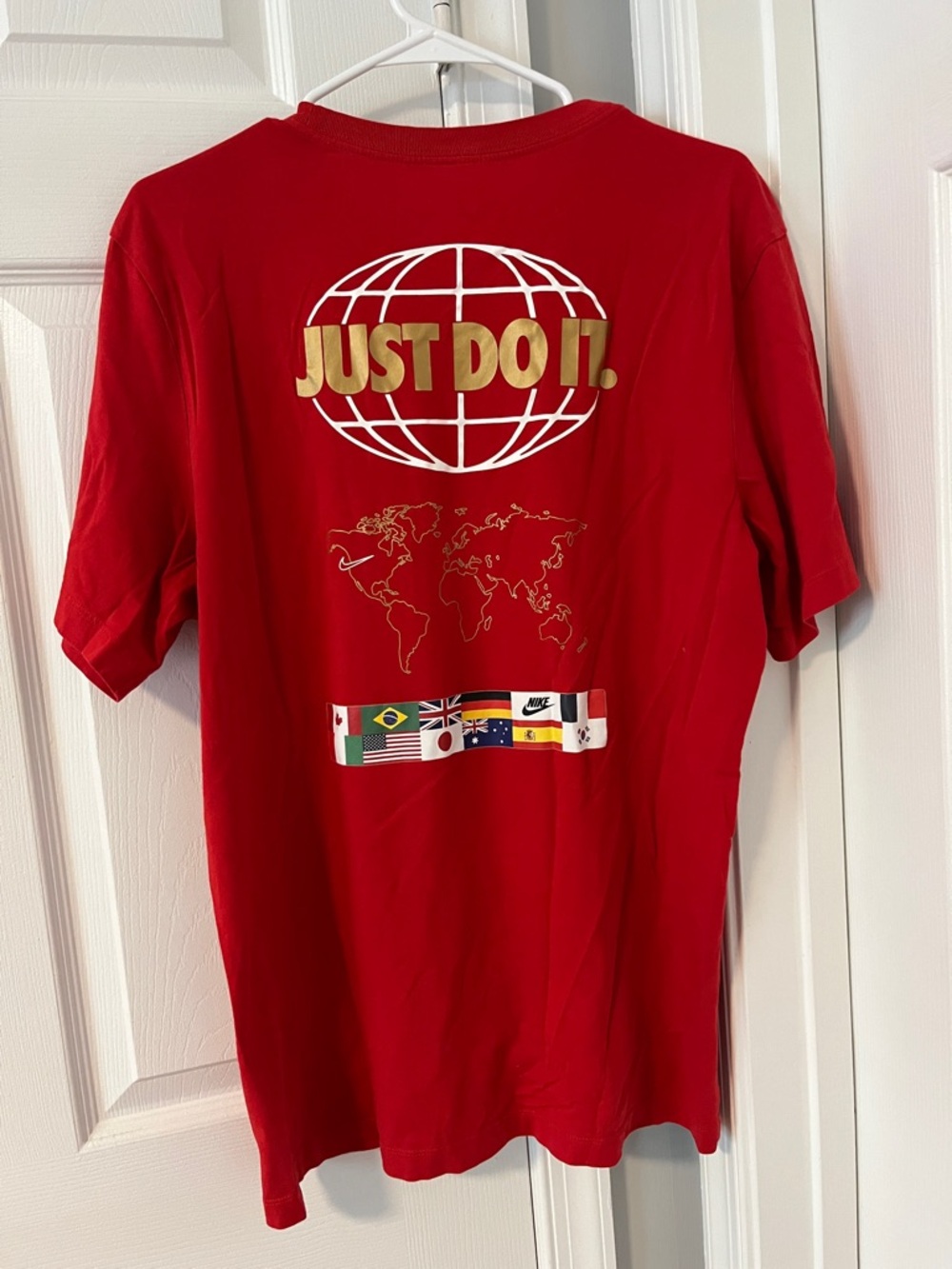 Nike Men’s Red Short Sleeve Tee with Gold "Just Do It." Globe Logo